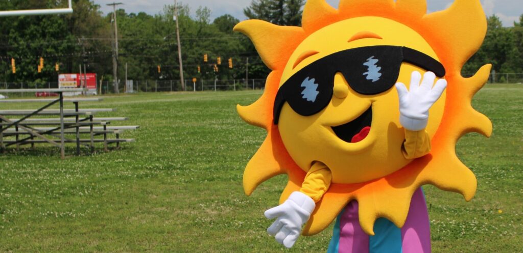 Mascot Ray F. Sun posing on a game field