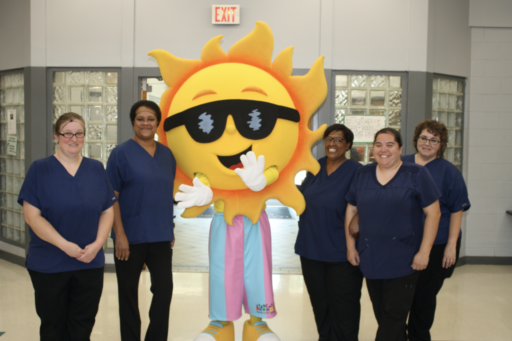 Mascot Ray F. Sun, posing with Rockingham County School Nutrition Staff