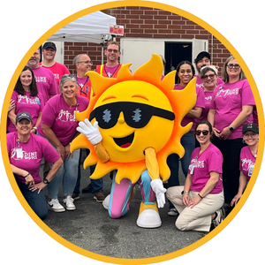 NC Summer Meals Mascot Ray F. Sun posing with Winston-Salem/Forsyth County Schools Nutrition Professionals